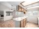 Eat-in kitchen featuring wood cabinets and white countertops open to dining area at 2228 S Eldridge St, Lakewood, CO 80228