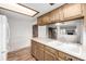 Kitchen area with wood cabinets, white counters, and stainless steel appliances at 2228 S Eldridge St, Lakewood, CO 80228