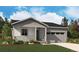Charming single-story home with a gray exterior, stone accents, well-manicured lawn, and attached two-car garage at 24745 E 41St Ave, Aurora, CO 80019