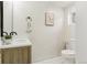 Modern bathroom featuring a wood vanity, a framed mirror, and contemporary toilet with stylish decor at 1472 Sinton Rd, Evergreen, CO 80439