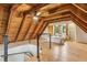 Bedroom with a high ceiling, wooden walls, hardwood floors and a comfortable queen sized bed at 1472 Sinton Rd, Evergreen, CO 80439