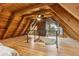 Spacious bedroom with a high ceiling, hardwood floors, and a view of the level below at 1472 Sinton Rd, Evergreen, CO 80439