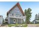 Shot of the exterior of a 2-story blue house with a white balcony, with an outbuilding and landscaping at 1472 Sinton Rd, Evergreen, CO 80439