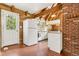 Bright kitchen featuring a full-sized refrigerator, white cabinetry, and rustic wooden beam ceiling at 1472 Sinton Rd, Evergreen, CO 80439