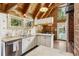 Charming kitchen with a brick accent wall and classic white cabinetry with modern countertops at 1472 Sinton Rd, Evergreen, CO 80439