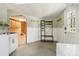Bright laundry room with ample storage and access to additional rooms through an arched doorway at 1472 Sinton Rd, Evergreen, CO 80439