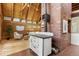 Spacious living room with exposed wood, fireplace, hardwood floors and a vintage stove at 1472 Sinton Rd, Evergreen, CO 80439
