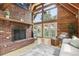 Inviting living room featuring a fireplace, exposed wood and a lot of natural light at 1472 Sinton Rd, Evergreen, CO 80439