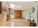 Versatile living space with wood-paneled walls, storage, and natural light from a nearby exterior door at 1472 Sinton Rd, Evergreen, CO 80439