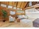 Bright living room with wood walls, wooden ceiling, hardwood floors, comfortable seating, and natural light at 1472 Sinton Rd, Evergreen, CO 80439