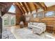 Bright living room with exposed wood and a cozy sitting area with a couch at 1472 Sinton Rd, Evergreen, CO 80439
