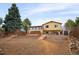 The backyard features a spacious yard, a patio area, and mature trees, ideal for outdoor activities and relaxation at 18130 E Asbury Dr, Aurora, CO 80013
