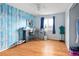Spacious bedroom featuring blue and white wood accent wall and a large window at 18130 E Asbury Dr, Aurora, CO 80013