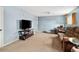 Cozy living room with plush carpeting, a large TV, and comfortable seating at 18130 E Asbury Dr, Aurora, CO 80013