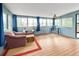 Bright sun room with wrap-around windows and hardwood floors, perfect for relaxation at 18130 E Asbury Dr, Aurora, CO 80013