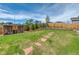 Lush green backyard with mature trees, stepping stones, a shed, and a wooden fence surround at 965 Arapahoe Cir, Louisville, CO 80027