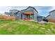 Landscaped backyard features a pergola over a patio, grassy area, and a stepping stone path at 965 Arapahoe Cir, Louisville, CO 80027