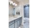 Bathroom features a modern vanity with gray cabinets, quartz counters, and a tiled shower over tub at 965 Arapahoe Cir, Louisville, CO 80027