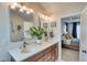 Stylish bathroom featuring double vanities, modern fixtures, and an adjacent bedroom view at 965 Arapahoe Cir, Louisville, CO 80027