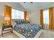 Bright bedroom with vaulted ceilings, plush carpet, and colorful floral bedding at 965 Arapahoe Cir, Louisville, CO 80027