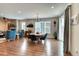Open-concept dining room with modern chandelier and hardwood floors leads into living area at 965 Arapahoe Cir, Louisville, CO 80027
