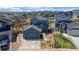 Charming two-story home with an attached garage, inviting landscape, and mountain views in the background at 965 Arapahoe Cir, Louisville, CO 80027