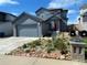 Charming two-story home with a well-maintained front yard and attached garage at 965 Arapahoe Cir, Louisville, CO 80027