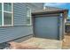 Detached garage with blue siding and ample parking space, matching the house's exterior at 965 Arapahoe Cir, Louisville, CO 80027