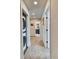 Hallway with stacked washer/dryer and access to a well appointed bathroom at 965 Arapahoe Cir, Louisville, CO 80027