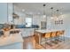 Bright kitchen featuring white cabinetry, stainless steel appliances, and a center island with bar stools at 965 Arapahoe Cir, Louisville, CO 80027