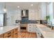 Bright kitchen featuring white cabinets, stainless steel appliances, blue backsplash, and quartz countertops at 965 Arapahoe Cir, Louisville, CO 80027
