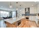 Modern kitchen with white cabinets, stainless steel appliances, quartz countertops, and an island with pendant lighting at 965 Arapahoe Cir, Louisville, CO 80027