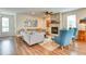 Inviting living room with a stone fireplace, comfortable seating, and hardwood floors at 965 Arapahoe Cir, Louisville, CO 80027