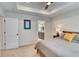 Comfortable main bedroom with tray ceilings, carpet floors, and an en-suite bathroom at 965 Arapahoe Cir, Louisville, CO 80027