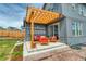 Image features an outdoor patio with a pergola, red outdoor furniture, and sliding glass doors at 965 Arapahoe Cir, Louisville, CO 80027