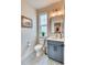 Stylish powder room with a modern vanity, decorative mirror, and patterned tile floor at 965 Arapahoe Cir, Louisville, CO 80027