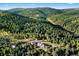 Aerial view of a home surrounded by lush greenery, highlighting the tranquil and private mountain setting at 12291 S Critchell Ln, Littleton, CO 80127
