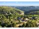 Stunning aerial view of a home in a lush, mountainous setting, highlighting the natural beauty and privacy of the location at 12291 S Critchell Ln, Littleton, CO 80127