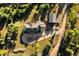 Aerial view of a home with a circular driveway and well-maintained landscaping, nestled amidst lush green trees at 12291 S Critchell Ln, Littleton, CO 80127