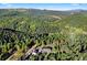 Scenic aerial view of a home nestled among lush green trees, showcasing its serene and private setting at 12291 S Critchell Ln, Littleton, CO 80127