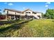 Backyard featuring a multi-level home with balconies, a fenced yard, and lush greenery, ideal for outdoor enjoyment at 12291 S Critchell Ln, Littleton, CO 80127