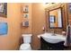 Charming powder room featuring textured walls and unique artistic accents at 12291 S Critchell Ln, Littleton, CO 80127