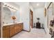Well-lit bathroom features double sinks, wood cabinetry, and a tiled shower for a functional yet stylish design at 12291 S Critchell Ln, Littleton, CO 80127