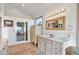 Bathroom featuring a walk-in shower, wooden mirror frame, and large vanity at 12291 S Critchell Ln, Littleton, CO 80127