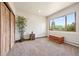 Bright room with a large window, neutral carpet, and wood accents creating a calming and versatile space at 12291 S Critchell Ln, Littleton, CO 80127