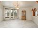Bright dining room featuring a chandelier, large windows, and custom built-in cabinet at 12291 S Critchell Ln, Littleton, CO 80127