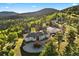 A beautiful mountain home with a large circular driveway and an additional garage at 12291 S Critchell Ln, Littleton, CO 80127