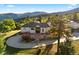 A beautiful home with a circular driveway, landscaping, and mountain views at 12291 S Critchell Ln, Littleton, CO 80127