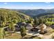 Stunning mountain home with a circular driveway and views of the surrounding green landscape at 12291 S Critchell Ln, Littleton, CO 80127