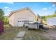 Exterior view of a detached two-car garage featuring white doors, a neutral facade, and a small trailer parked in front at 12291 S Critchell Ln, Littleton, CO 80127